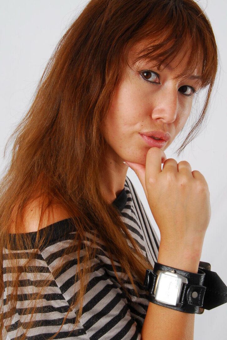 16P Asian redhead Evita glances at her huge Frilis watch while fully clothed
