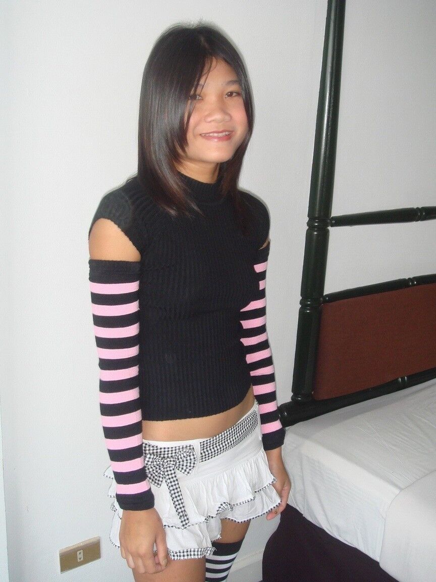 16P Young Asian girl drinks a beer while disrobing to arm socks and thigh highs