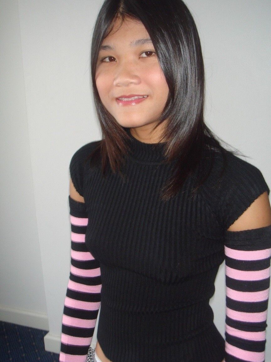 16P Young Asian girl drinks a beer while disrobing to arm socks and thigh highs