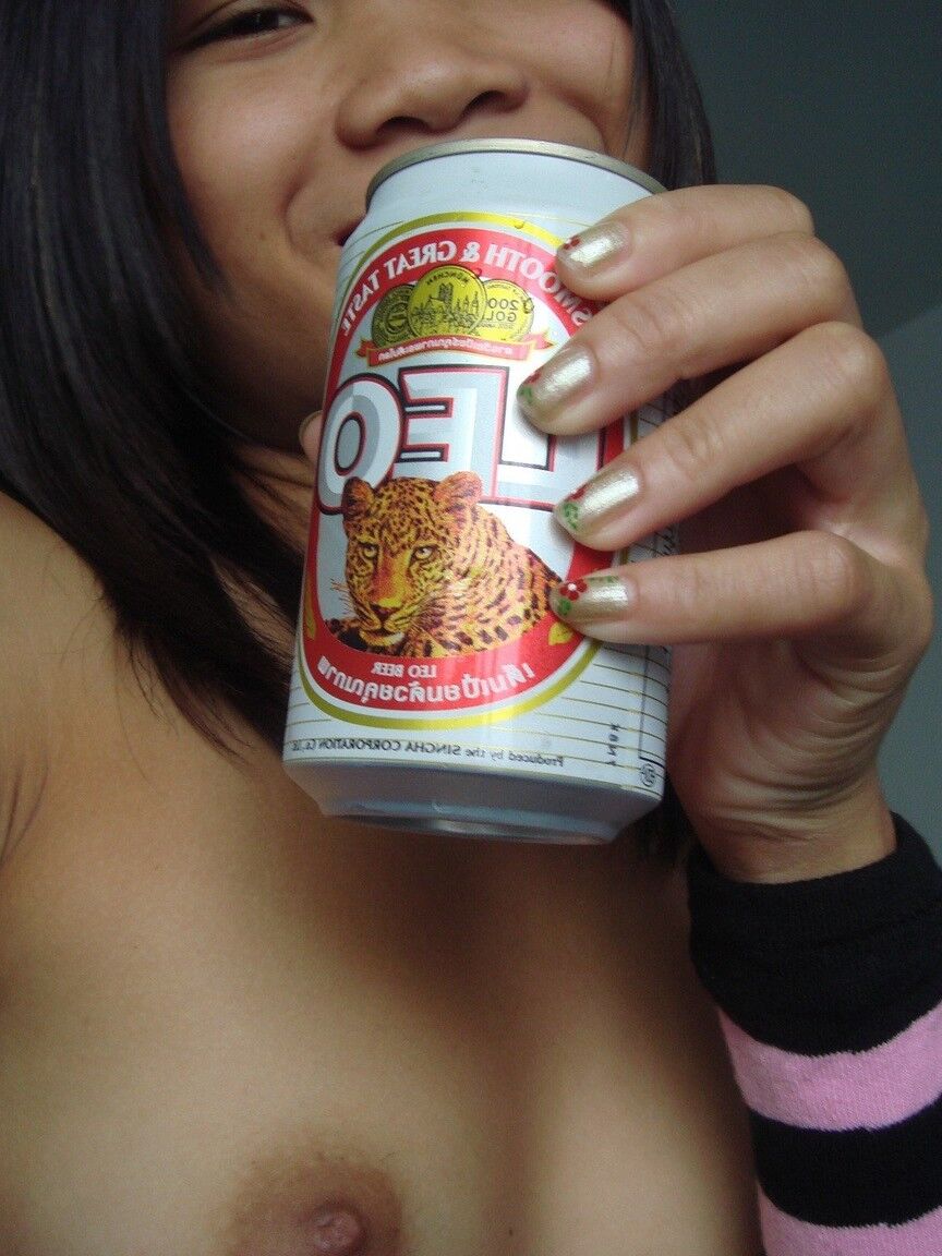 16P Young Asian girl drinks a beer while disrobing to arm socks and thigh highs