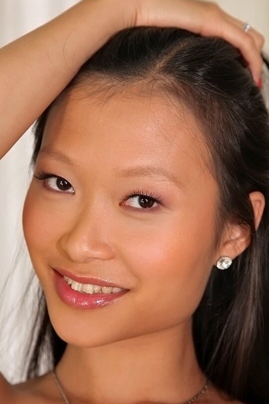 16P Slippy asian sweetie with round bosoms undressing and posing on the bed