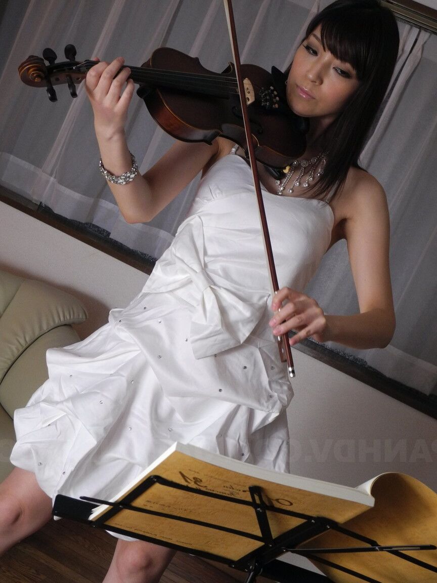 21P Brunette babe with small tits Yuria Tominaga rubs her vagina with a fiddle bow