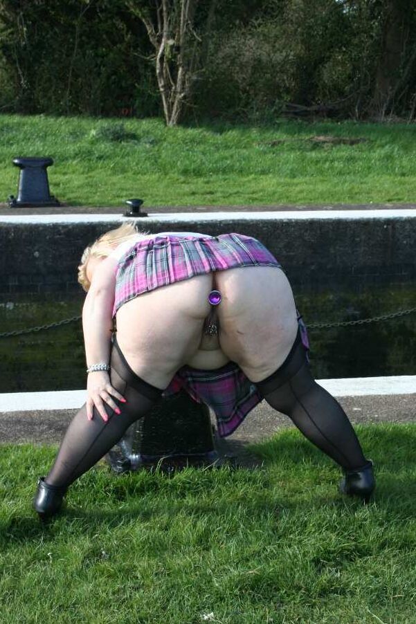 19P Obese blonde Lexie Cummings sports a butt plug while pissing in a parking lot