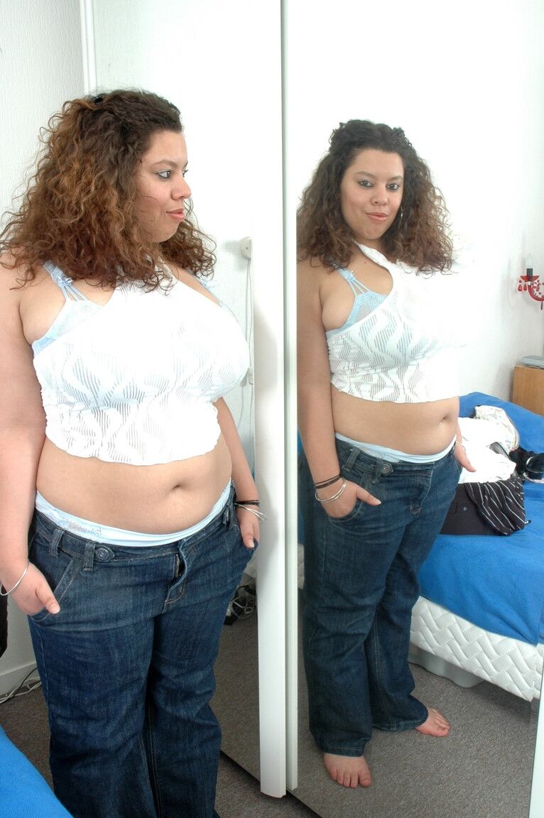 21P Curvy amateur with curly hair Soraya exposes her brilliant breasts in a solo