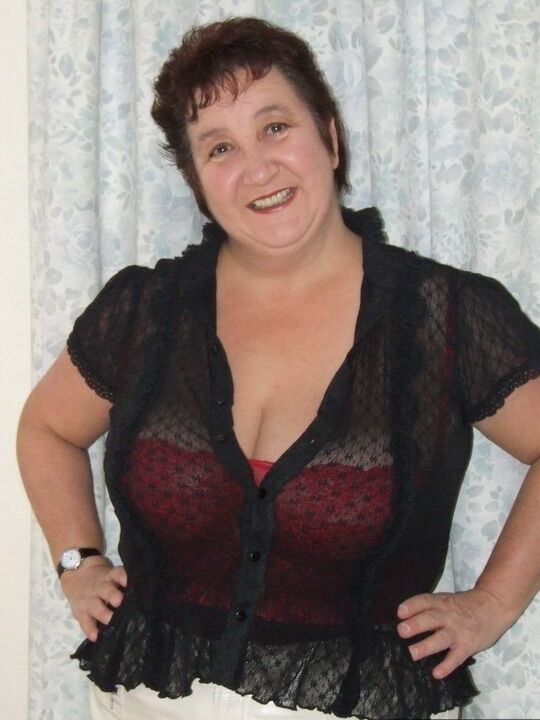 20P Chubby older lady Kinky Carol slips a miniskirt over her thong clad butt