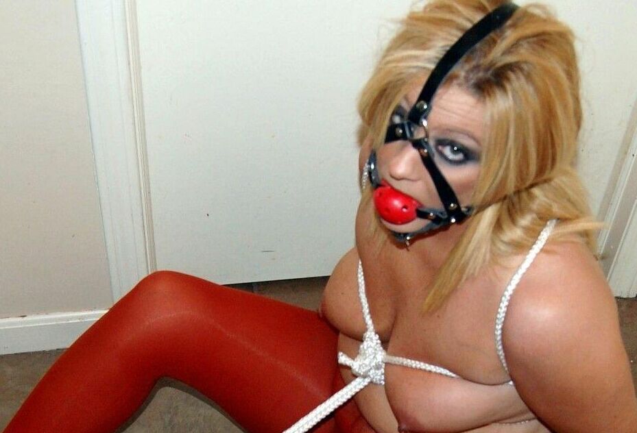15P Thick blonde Adrienna has her tits tied up with rope while ball gagged in hose