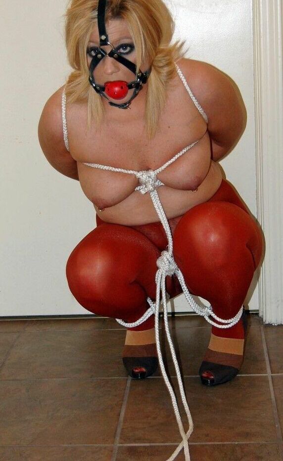 15P Thick blonde Adrienna has her tits tied up with rope while ball gagged in hose