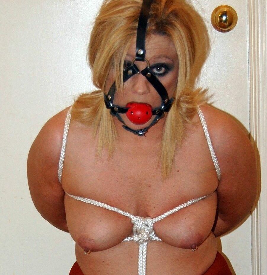 15P Thick blonde Adrienna has her tits tied up with rope while ball gagged in hose