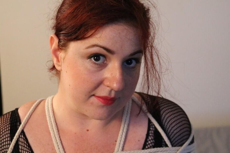 16P Redheaded fatty is silenced with medical tape while tied up with rope on a bed