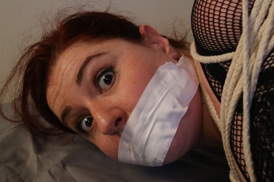 16P Redheaded fatty is silenced with medical tape while tied up with rope on a bed
