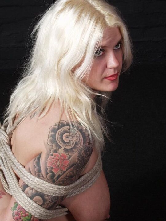 12P Tattooed blonde with saggy breasts gets tied up with rope in the nude