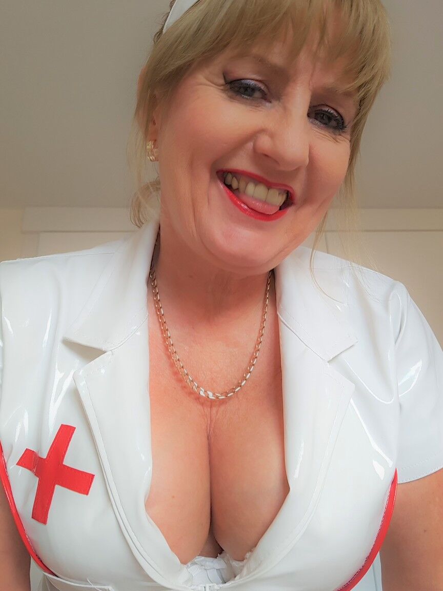 16P Mature nurse Lorna Blu displays her big ass and big cleavage in a solo