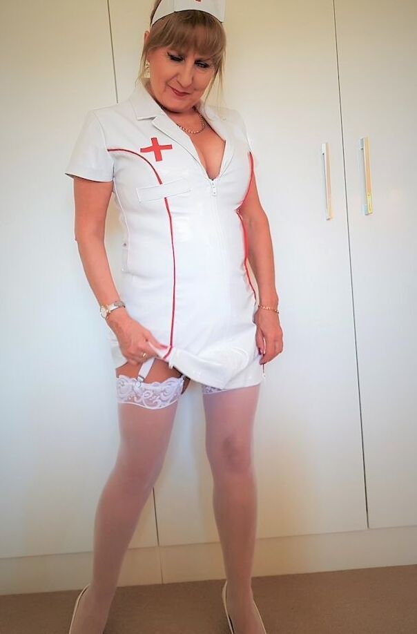 16P Mature nurse Lorna Blu displays her big ass and big cleavage in a solo
