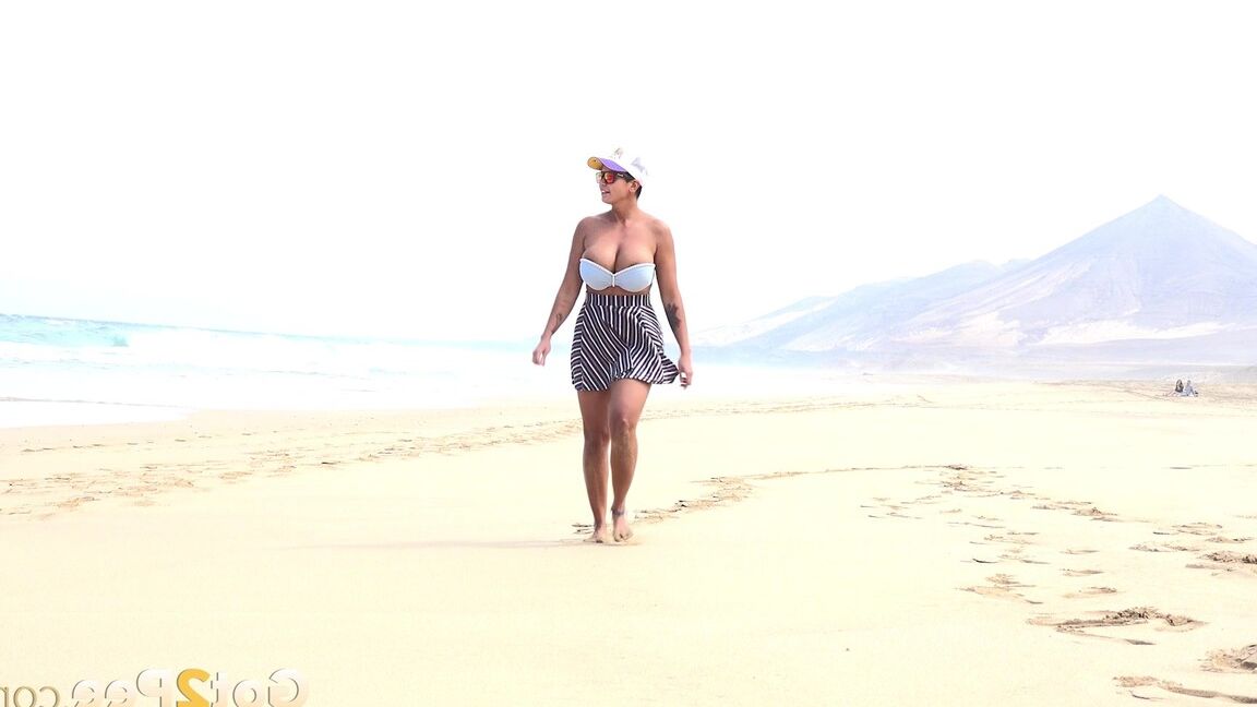 15P Caucasian female Chloe takes a piss while while traipsing on a deserted beach