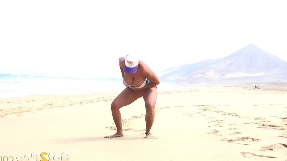 15P Caucasian female Chloe takes a piss while while traipsing on a deserted beach