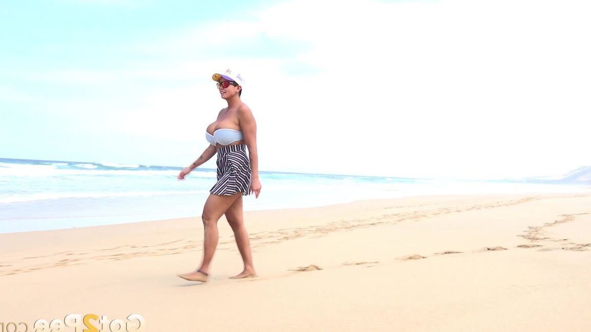 15P Caucasian female Chloe takes a piss while while traipsing on a deserted beach