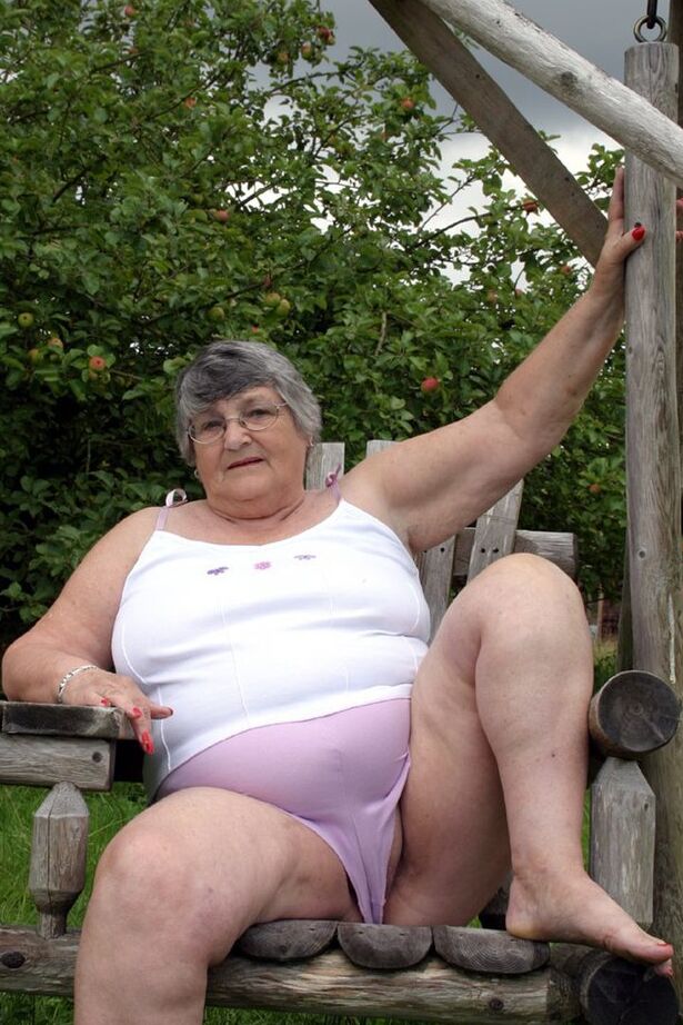 20P La abuela británica Libby expone sus tetas en un columpio en el banco del patio trasero