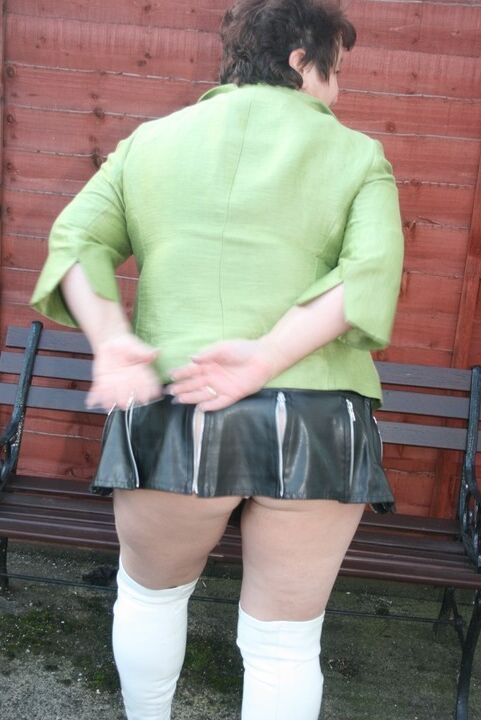 16P Fat older woman Kinky Carol models a bra and microskirt in over the knee boots