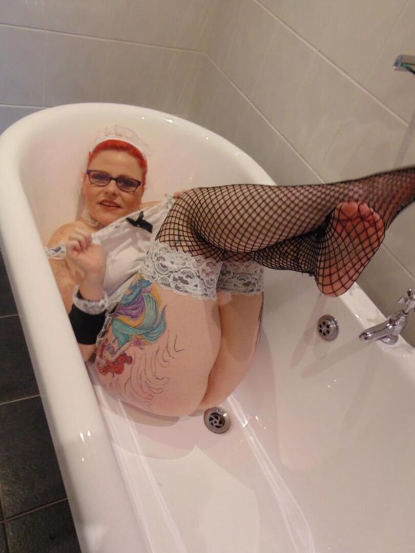 16P Older redhead Mollie Foxxx displays her natural tits while in a bathtub