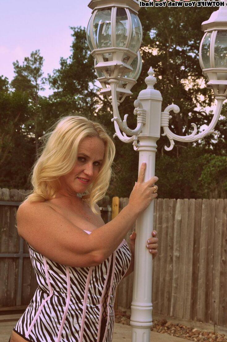 17P Blonde amateur Dee Siren displays her big ass in mesh stockings and garters