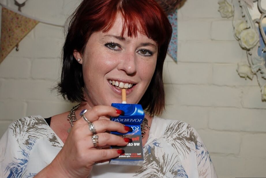 20P Redhead amateur BBW smokes while sliding cutoff shorts aside on a couch