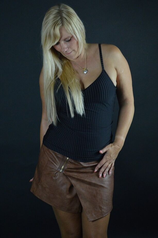 20P La rubia amateur Sweet Susi se quita una falda de cuero mientras usa medias