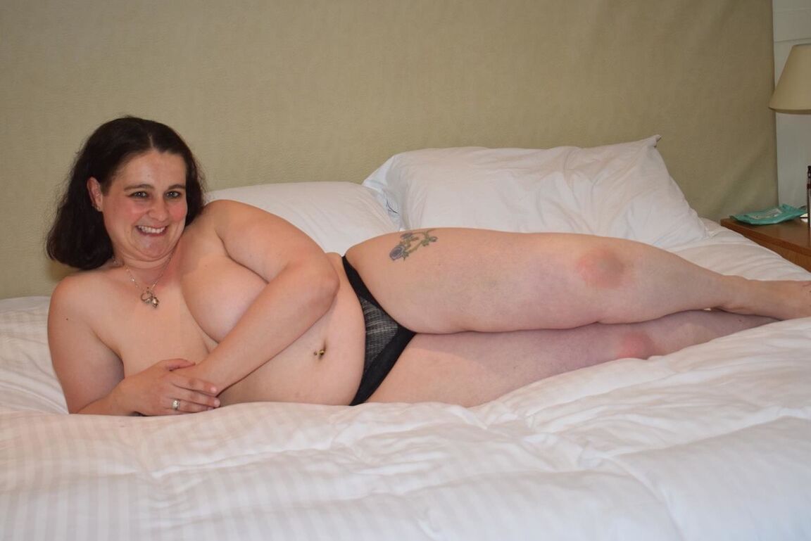 16P Overweight brunette sets her big boobs free of naughty nurse attire on a bed