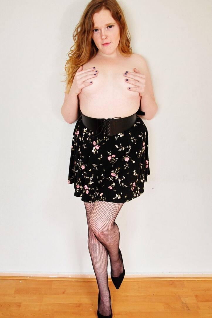 16P Natural redhead displays her small tits during upskirt action in mesh nylons