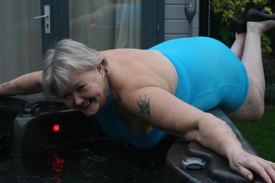 20P Abuela gorda se levanta un vestido transparente para exponer su vagina con zapatos de tacón negros