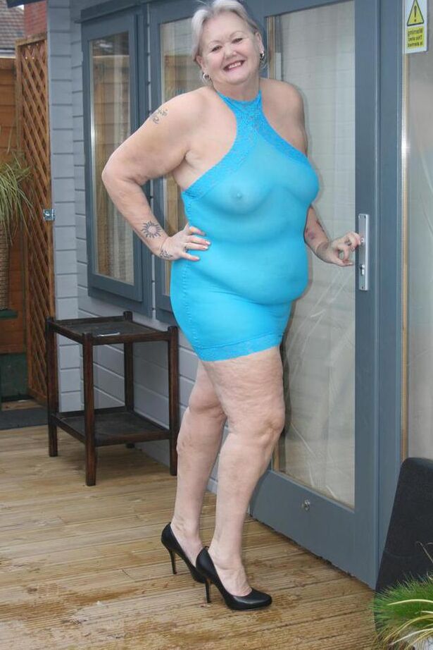 20P Abuela gorda se levanta un vestido transparente para exponer su vagina con zapatos de tacón negros