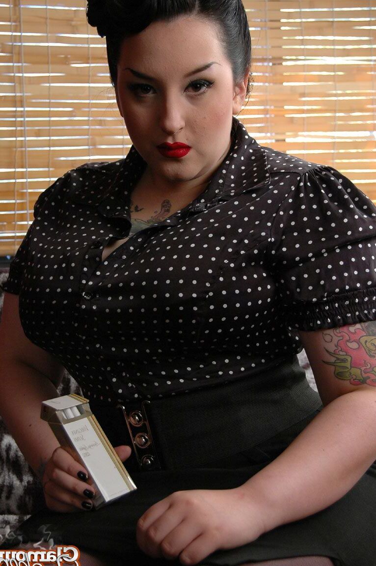 15P Fully clothed fat woman Kerosene wraps red lips around a cigarette