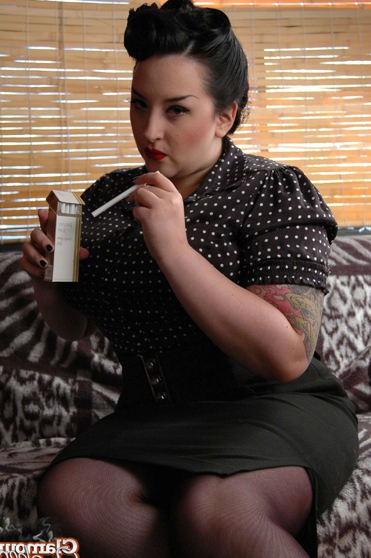 15P Fully clothed fat woman Kerosene wraps red lips around a cigarette