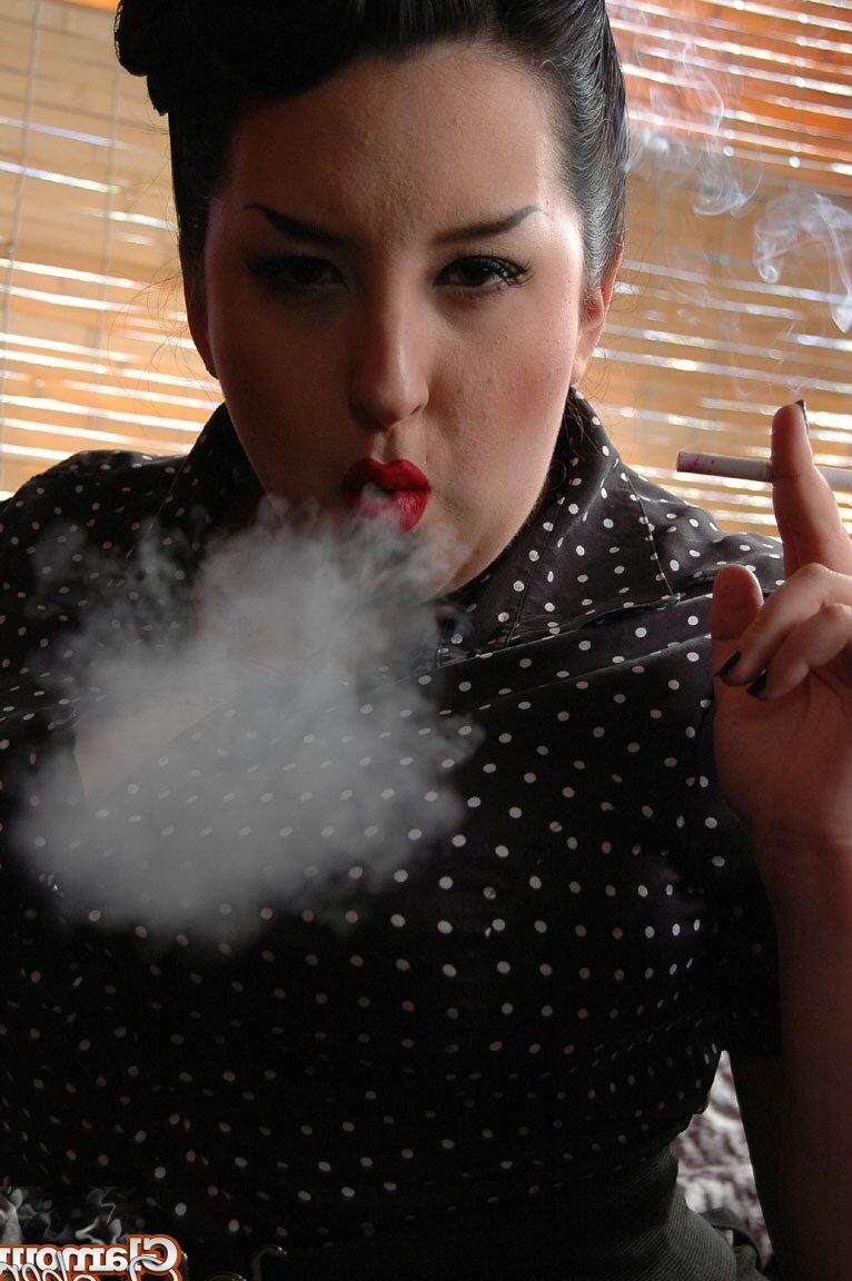 15P Fully clothed fat woman Kerosene wraps red lips around a cigarette