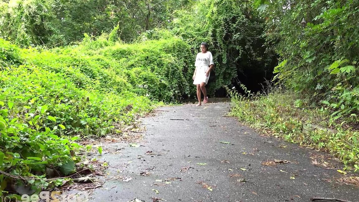15P Solo female Chloe Lamour takes a piss on a paved path while wearing sandals