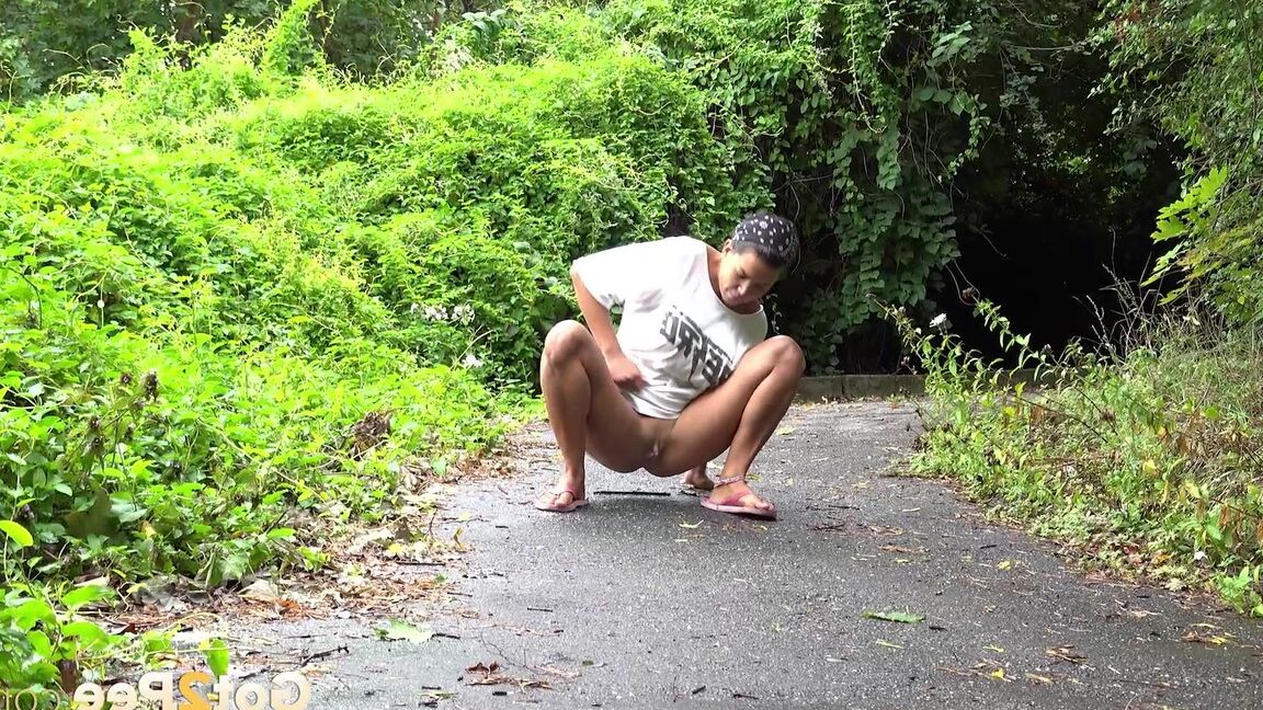 15P Solo female Chloe Lamour takes a piss on a paved path while wearing sandals