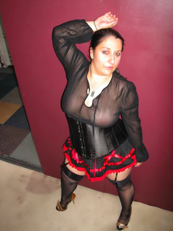 20P Amateur brunette displays her big butt while wearing garters and nylons