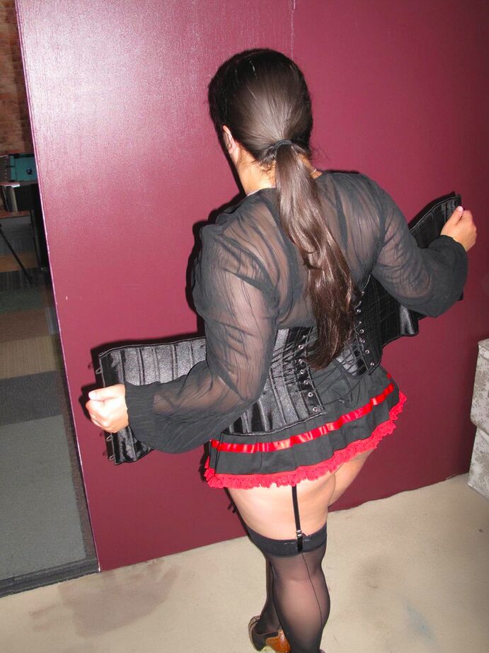 20P Amateur brunette displays her big butt while wearing garters and nylons