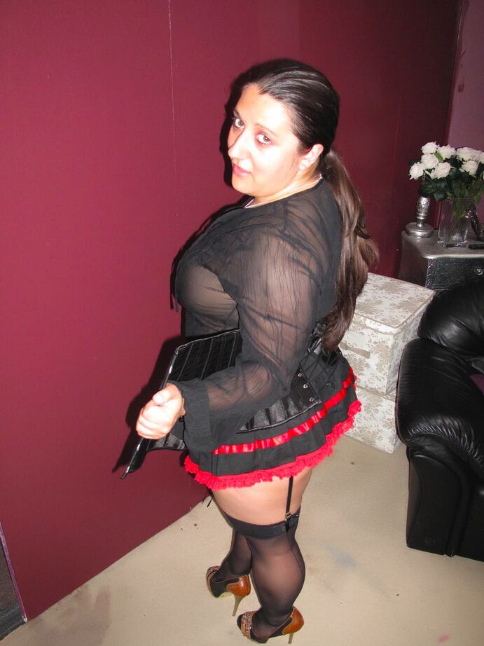 20P Amateur brunette displays her big butt while wearing garters and nylons