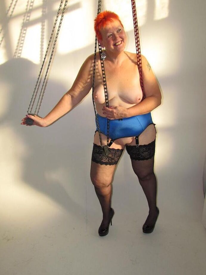 20P Thick redhead Valgasmic Exposed changes garter belts while naked in stockings
