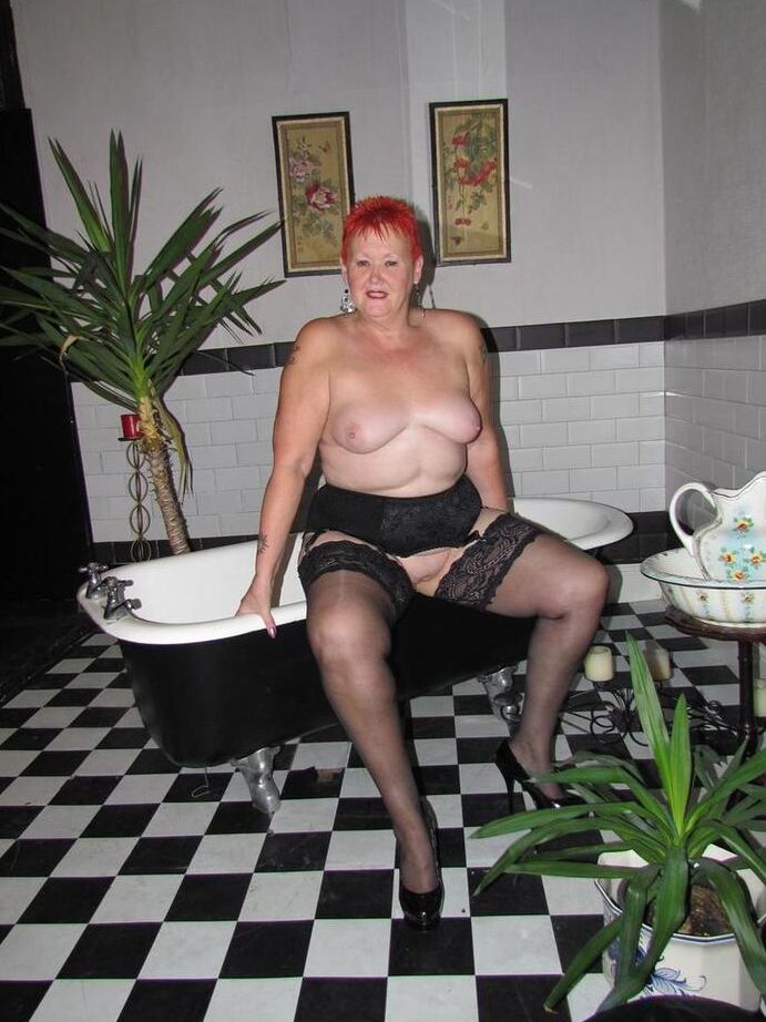 20P Thick redhead Valgasmic Exposed changes garter belts while naked in stockings