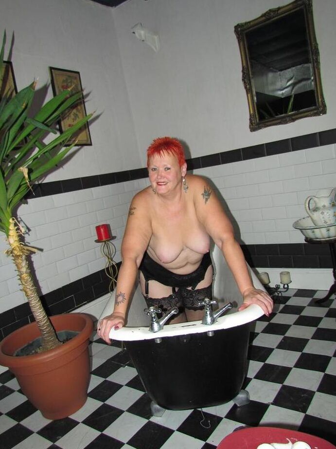20P Thick redhead Valgasmic Exposed changes garter belts while naked in stockings