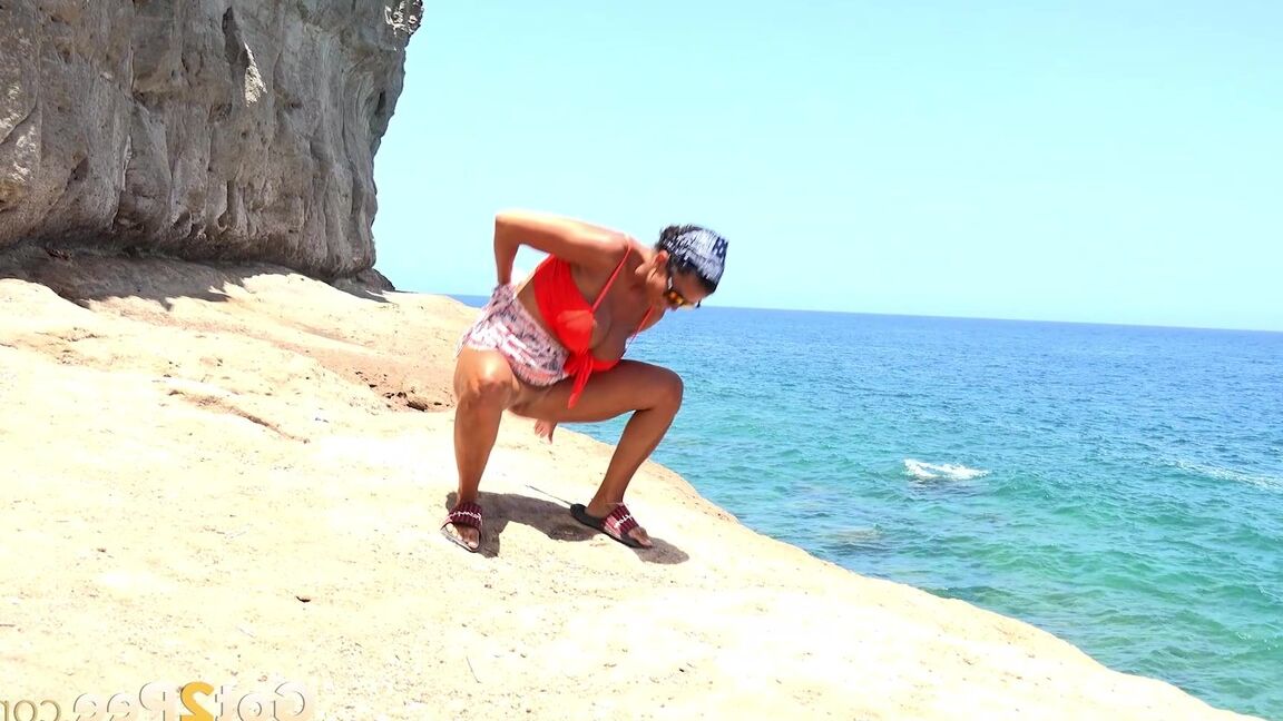 15P Caucasian girl Chloe Lamour takes a piss while walking upon a seaside cliff