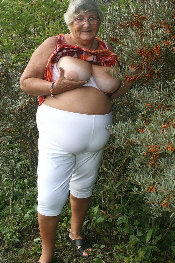20P Obese nan Grandma Libby strips totally naked out by evergreen trees