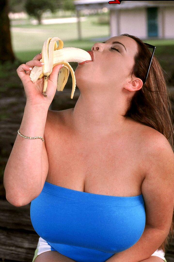 15P Thick chick Annie Swanson eats a banana before baring her breasts in a park