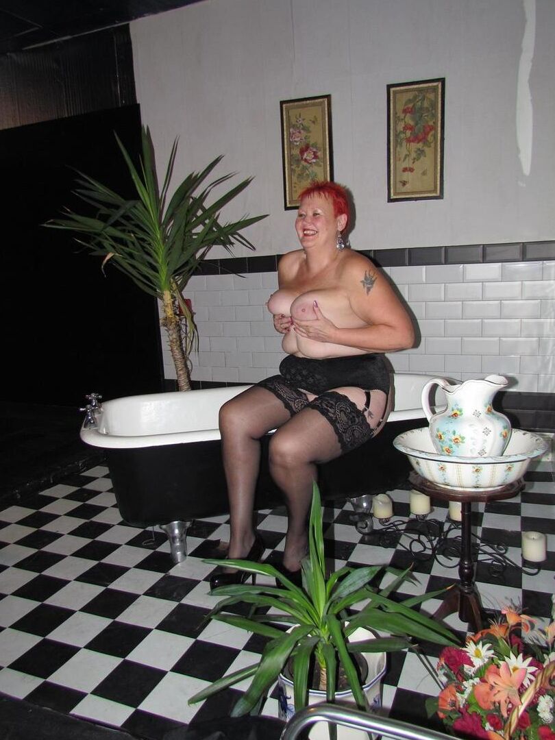 20P Older redhead Valgasmic Exposed steps into a bathtub while wearing stockings