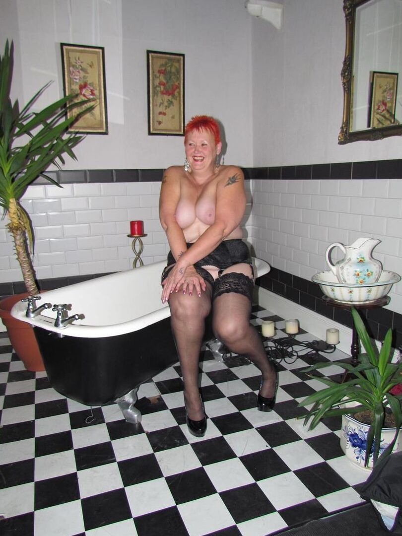 20P Older redhead Valgasmic Exposed steps into a bathtub while wearing stockings