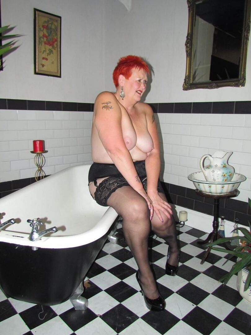 20P Older redhead Valgasmic Exposed steps into a bathtub while wearing stockings