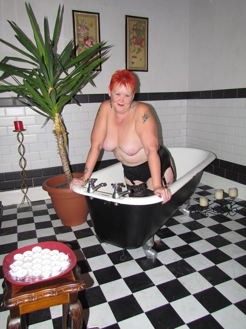 20P Older redhead Valgasmic Exposed steps into a bathtub while wearing stockings