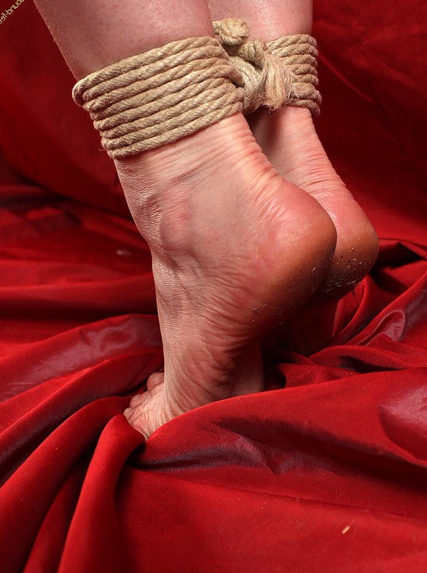 16P Natural redhead is forced to stand on tiptoes while tied with rope in a corset
