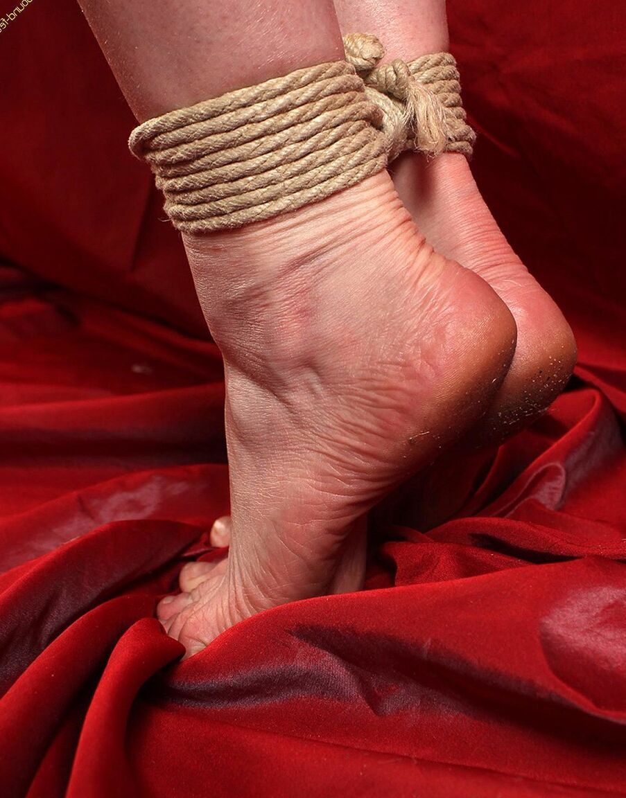 16P Natural redhead is forced to stand on tiptoes while tied with rope in a corset